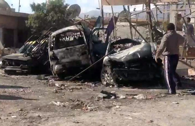   In this photo released by the Syrian official news agency SANA, Syrian citizens gather next to cars that were destroyed by a car bomb in Qatana, (25) kilometers (15 miles) southwest of Damascus, Syria, Thursday, Dec. 13, 2012. A bomb blast near a school in a Damascus suburb killed more than a dozen people, at least half of them women and children, the state news agency reported. Russia, Syria's most important international ally, said for the first time that President Bashar Assad is increasingly losing control and the opposition may win the civil war. (AP Photo/SANA)  