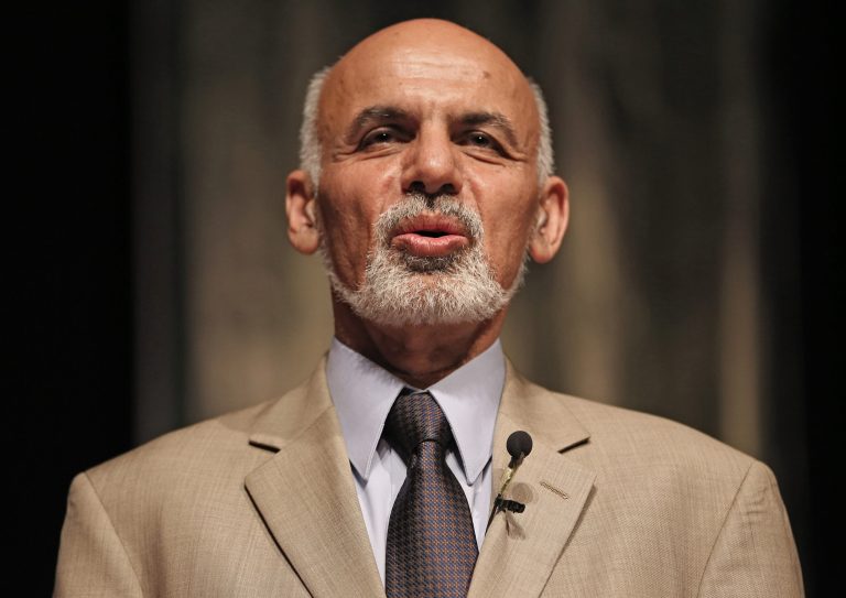 FILE - In this file photo taken on Wednesday, June 11, 2014, Afghanistan's presidential candidate Ashraf Ghani Ahmadzai stands as he listens to the national anthem during his last campaign rally in Kabul, Afghanistan. A proposal for the U.N. to mediate a crisis over allegations of election fraud gained momentum Friday, June 20, as President Hamid Karzai backed the idea and the U.N. said it stood ready to help. (AP Photo/Massoud Hossaini, File)