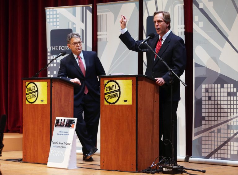 Sen. Al Franken, left, listens as his Republican challenger Mike McFadden gives his closing statement during their Oct. 1 debate in Duluth, Minn. (AP/Jim Mone)