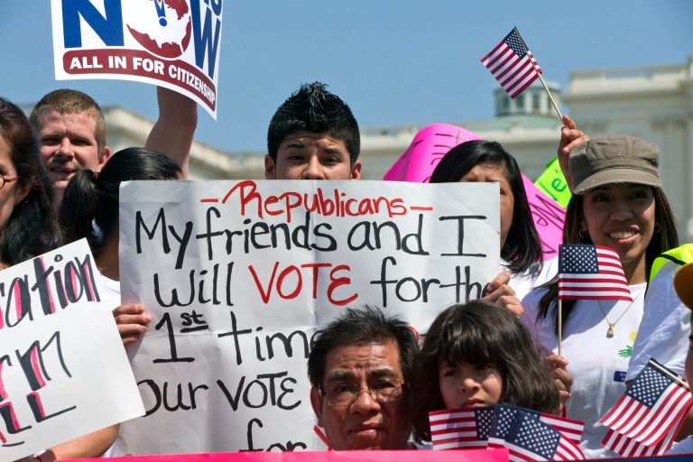 A boy holds a sign to Republicans stating 
