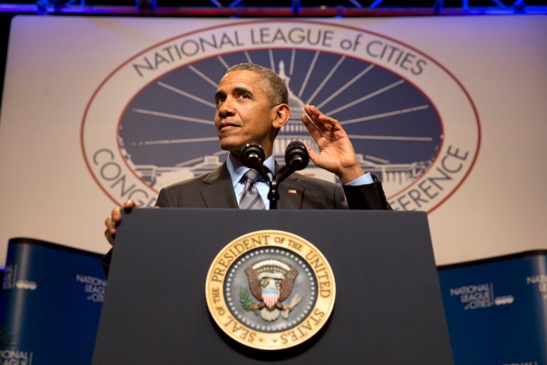 President Barack Obama gestures that he is listening to the crowd as he speaks at the National League of Cities annual Congressional City Conference in Washington, Monday, March 9, 2015. (AP Photo/Jacquelyn Martin)