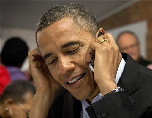 In this Nov. 5, 2012, photo, President Barack Obama makes a call to thank a volunteer as he visits a call center in a campaign office in the German Village section of Columbus, Ohio. In the end, Obama won re-election exactly the way his campaign had predicted: running up big margins with women and minorities, mobilizing a sophisticated registration and get-out-the-vote operation and focusing narrowly on the battleground states that would determine the election. It wasn't always exciting, and it was hardly transformational. But it worked. (AP Photo/Carolyn Kaster)