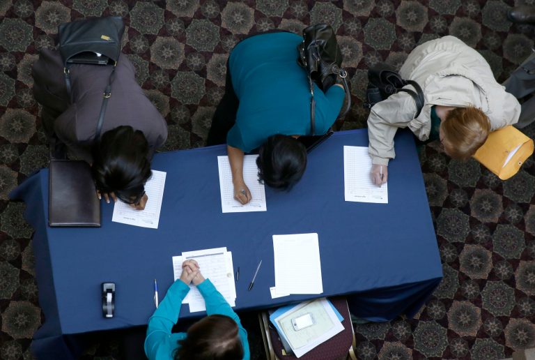 FILE - In this Jan. 22, 2014, file photo, job seekers sign in before meeting prospective employers during a career fair at a hotel in Dallas. The Labor Department releases weekly jobless claims, on Thursday, April 3, 2014. (AP Photo/LM Otero)