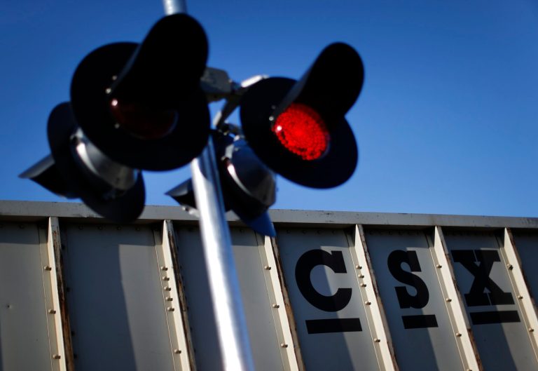 In this March 22, 2014 picture, a CSX freight train rolls past a grade crossing in Mt. Airy, Md. CSX reports quarterly earnings on Tuesday, July 15, 2014. ( (AP Photo/Patrick Semansky)