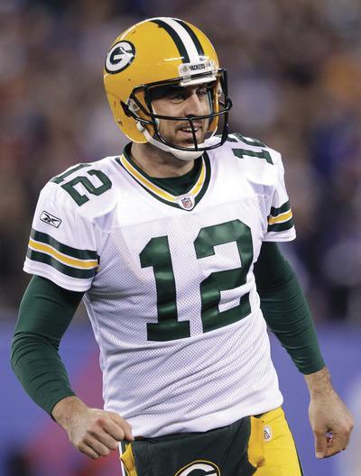 Green Bay Packers'Aaron Rodgers smiles after a play during the third quarter of an NFL football game against the New York Giants on Sunday, Dec. 4, 2011, in East Rutherford, N.J.(AP Photo/Julio Cortez)