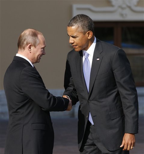 U.S. President Barack Obama, right, shakes hands with Russia's President Vladimir Putin during arrivals for the G-20 summit at the Konstantin Palace in St. Petersburg, Russia on Thursday, Sept. 5, 2013. The threat of missiles over the Mediterranean is weighing on world leaders meeting on the shores of the Baltic this week, and eclipsing economic battles that usually dominate when the G-20 world economies meet. (AP Photo/Alexander Zemlianichenko)
