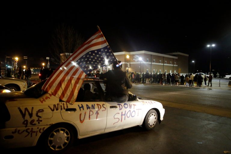 People protest outside the Ferguson Police Department headquarters Saturday. (AP Photo/Jeff Roberson)