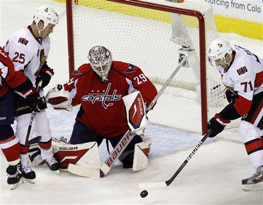 Washington Capitals goalie Tomas Vokoun (29), of the Czech Republic, covers the net against Ottawa Senators left wing Nick Foligno (71) and right wing Chris Neil (25) during the first period of an NHL hockey game in Washington, Saturday, Oct. 15, 2011. The Capitals beat the Senators 2-1. (AP Photo/Ann Heisenfelt)