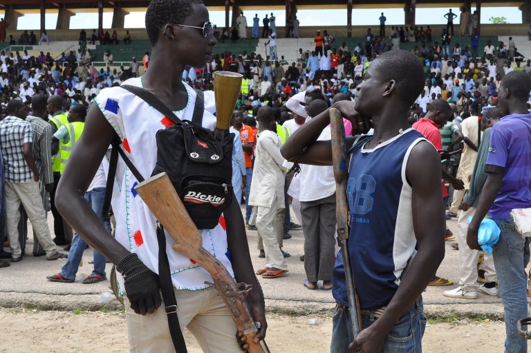 Vigilante and local hunters armed with guns gather outside the Emir's palace in Maiduguri, Nigeria, Thursday, Sept. 4, 2014. The United States is preparing to launch a 