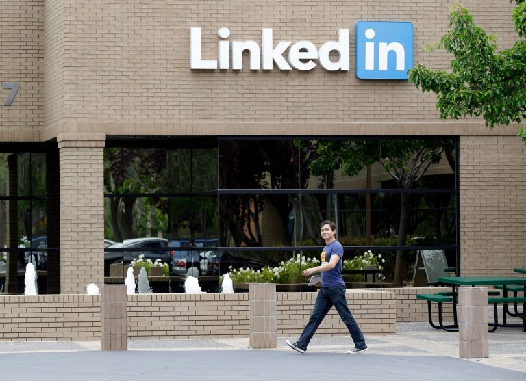A man walks past the LinkedIn headquarters in Mountain View , Calif. on Thursday, May 8, 2014. The Oakland Tribune reports that the company is proposing adding multiple office buildings in Mountain View, its headquarters, that could total as much as 2.9 million square feet. The news comes as LinkedIn has signed a lease to occupy an entire 26-story building going up in San Francisco. (AP Photo/Marcio Jose Sanchez)