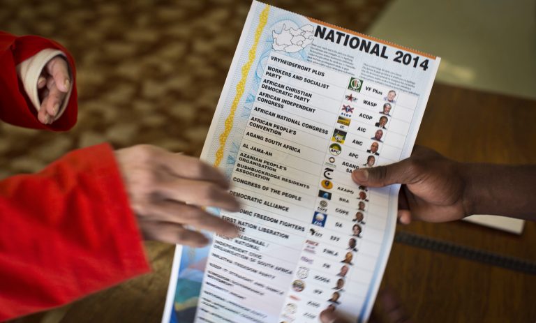 Election workers hand over ballot papers to elderly and disabled South African voters to cast their ballots during early voting for special groups at the Nazareth House old-age home in Johannesburg, South Africa Monday, May 5, 2014. South Africa goes to the polls on Wednesday, May 7, 2014 in elections that are likely to see the ruling African National Congress (ANC) party return to power with a smaller majority due to voters disaffected by corruption in government and economic inequality. (AP Photo/Ben Curtis)