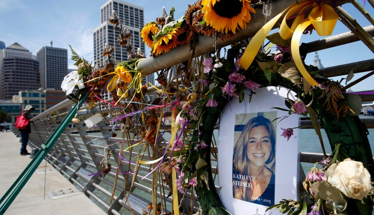 Fowers and a portrait of Kate Steinle remain at a memorial site on Pier 14 in San Francisco. Steinle's alleged killer, a Mexican man who was deported five times, was found not guilty of fatally shooting her in an apparent random incident in California more than two years ago. (Paul Chinn /San Francisco Chronicle via AP, File)
