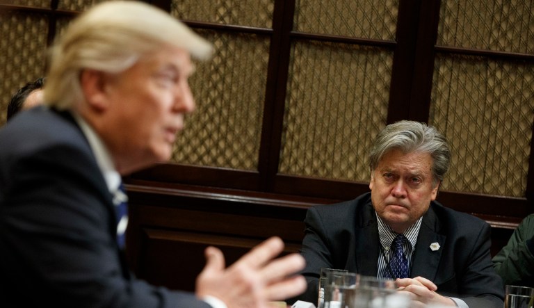 Steve Bannon listens at right as President Trump speaks.