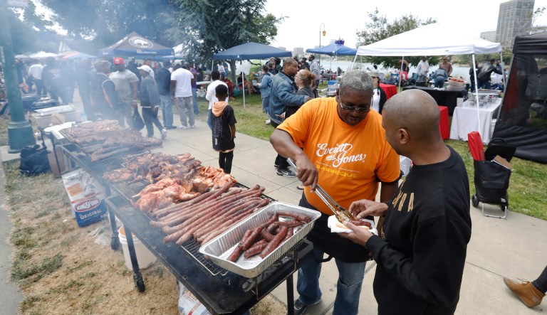 Lamont Patton, second from right, from Everett & Jones Barbeque cooks up a free feast at the "BBQ-ing while Black" event at Lake Merritt off Lakeshore Avenue in Oakland, Calif., on Sunday, May 20, 2018. Hundreds in the African American community came out to Lake Merritt in response to a confrontation caught on video there a few weeks ago when someone complained to police about a group of black people barbecuing. 