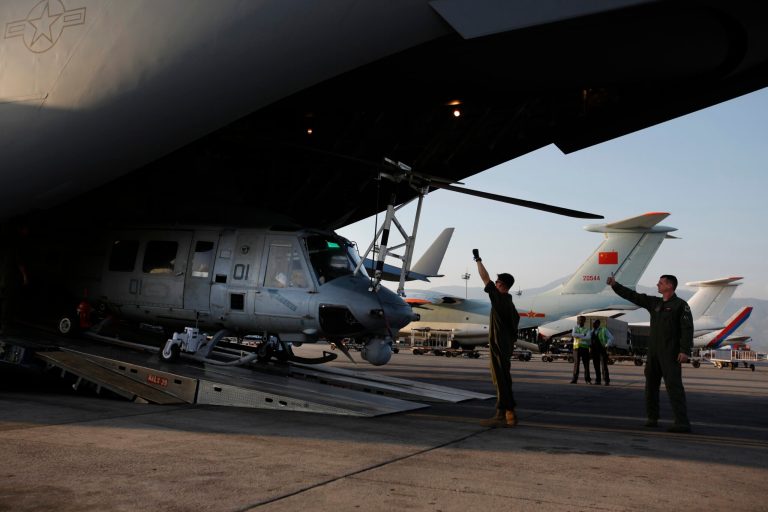 US soldiers unload Huey helicopters from a US Air Force Boeing C-17 Globemaster III after the same landed at the Tribhuvan International Airport in Kathmandu, Nepal, Sunday, May 3, 2015. (AP Photo/Niranjan Shrestha)