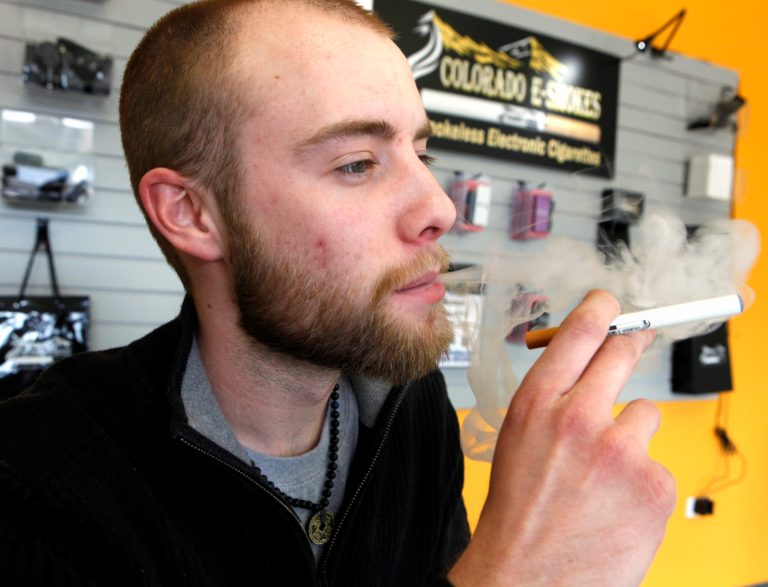 Blair Roberts, a 22-year-old sales associate at Colorado E-Smokes, demonstrates the use of a electronic cigarette and the smokelike vapor that comes from it at an E-Smokes store in Aurora, Colo. (AP File)