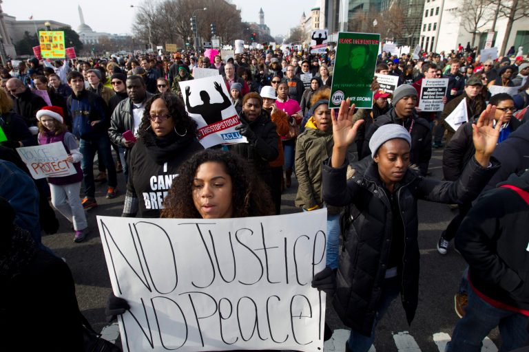 Demonstrators march on Pennsylvania Avenue toward Capitol Hill in Washington, Saturday, Dec. 13, 2014, during the Justice for All rally. More than 10,000 protesters are converging on Washington in an effort to bring attention to the deaths of unarmed black men at the hands of police. Civil rights organizations are holding a march to the Capitol on Saturday with the families of Michael Brown and Eric Garner, two unarmed black men who died in incidents with white police officers. (AP Photo/Jose Luis Magana)