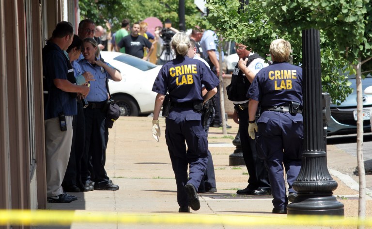 St. Louis police work the scene where four people were found dead in a business along Cherokee Street south of downtown in St. Louis, on Thursday, June 13, 2013. The St. Louis Police Department posted on its official Twitter account that two women and two men are dead. (AP Photo/St. Louis Post-Dispatch, Robert Cohen) EDWARDSVILLE INTELLIGENCER OUT; THE ALTON TELEGRAPH OUT