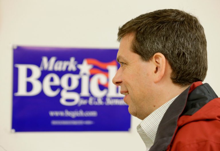 U.S. Sen. Mark Begich, D-Alaska, stands near a campaign sign as he visits one of his campaign offices Monday, Nov. 3, 2014, in Anchorage, Alaska. (AP Photo/Ted S. Warren)
