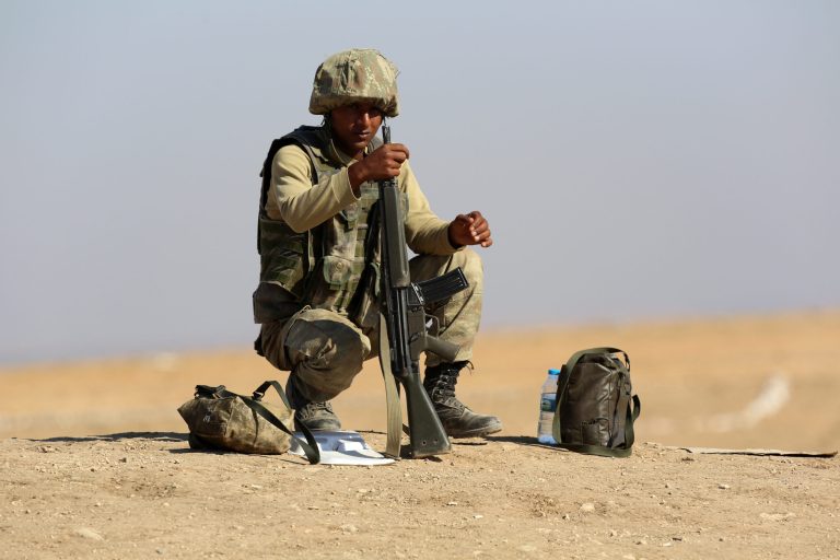 A Turkish soldier takes his position a few hundreds meters from the  the Turkey-Syria border in Mursitpinar, near Suruc, Turkey, as fighting intensified between Syrian Kurds and the militants of Islamic State Sunday Oct. 5, 2014. Kobani and its surrounding areas have been under attack since mid-September, with militants capturing dozens of nearby Kurdish villages. (AP Photo/Burhan Ozbilici)