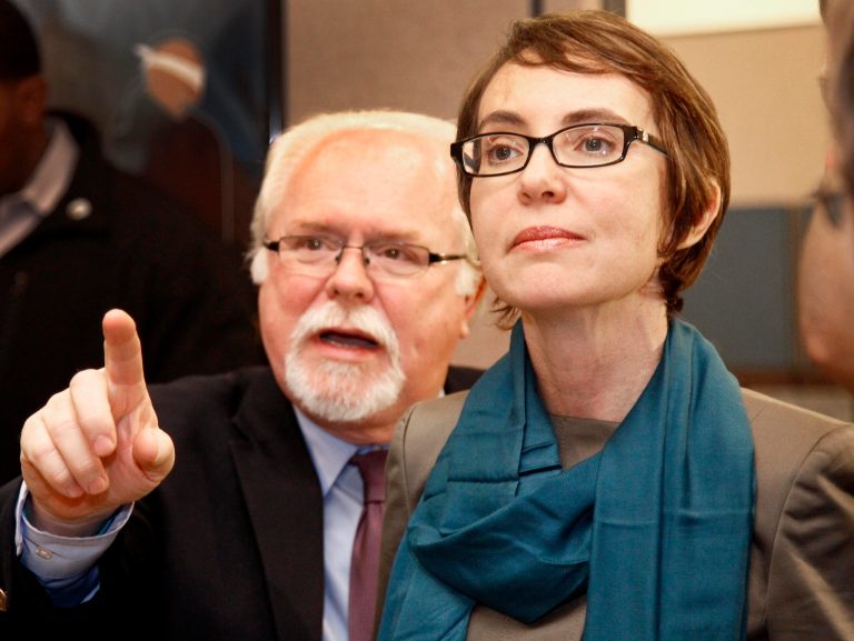   FILE - This Jan. 23, 2012 file, photo shows then-Rep Gabrielle Giffords, D-Ariz., touring the Gabrielle Giffords Family Assistance Center, one of her favorite charities, with staff member Ron Barber in Tucson, Ariz. Republicans are focusing on President Barack Obama, not Giffords, and sensing a chance to capture the former congresswoman's seat in southern Arizona. Voters are deciding in the Tuesday, June 12, 2012, special election whether Republican Jesse Kelly, who narrowly lost to Giffords in 2010, or Democrat Ron Barber, a former Giffords aide asked by the lawmaker to pursue the seat, will complete the remainder of her term. (AP Photo/Matt York, Pool, File)  
