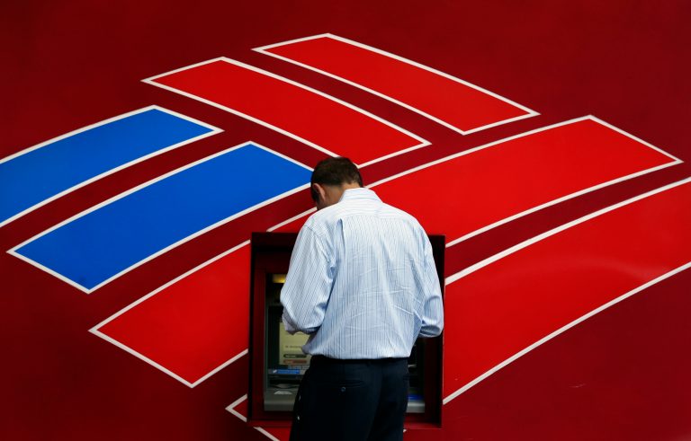 FILE - In this July 16, 2013 file photo, a customer uses a Bank of America  ATM in downtown Charlotte, N.C. Bank of America reports quarterly financial results on Wednesday, Oct. 15, 2014. (AP Photo/Chuck Burton, File)