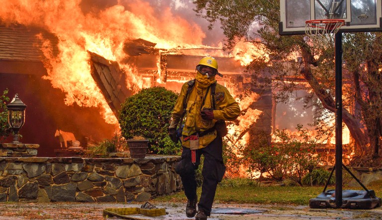 At least 15 fires had destroyed roughly 1,500 residential and commercial structures and had burned more than 73,000 acres across eight counties. (Jeff Gritchen/The Orange County Register via AP)