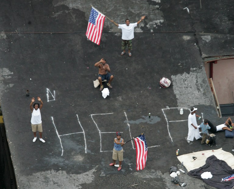 Residents wait on a rooftop to be rescued from the floodwaters of  Hurricane Katrina in New Orleans on Sept. 1, 2005. (AP Photo/David J. Phillip, Pool, File)