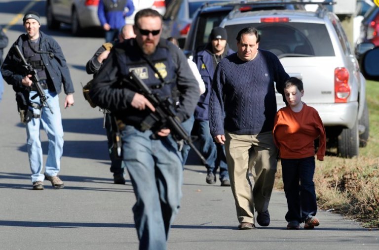 Police accompanying parents and children after the December shootings at Sandy Hook Elementary School in Newtown, Conn. AP Photo/Jessica Hill