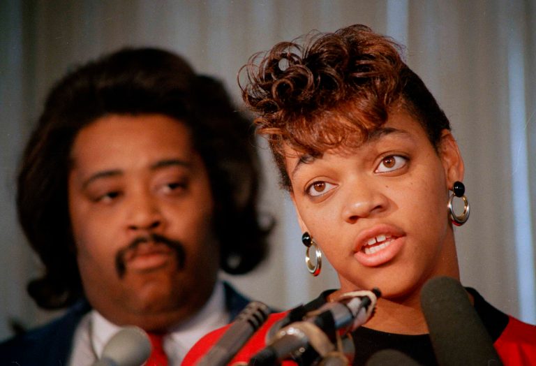 Tawana Brawley speaks to reporters with her advisor, the Rev. Al Sharpton, in Chicago on Oct. 8, 1988. A grand jury concluded Brawley's story of being raped in New York in 1987 was a hoax. (AP File)