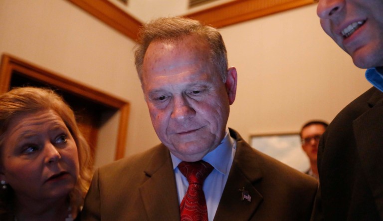 Republican U.S. Senate candidate Roy Moore, center, looks at election returns with staff during an election-night watch party at the RSA activity center, Tuesday, Dec. 12, 2017, in Montgomery, Ala. (AP Photo/Brynn Anderson)