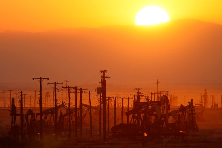 The sun rises over an oil field over the Monterey Shale formation where gas and oil extraction using hydraulic fracturing, or fracking, is on the verge of a boom on March 24, 2014 near Lost Hills, California. (Photo by David McNew/Getty images)