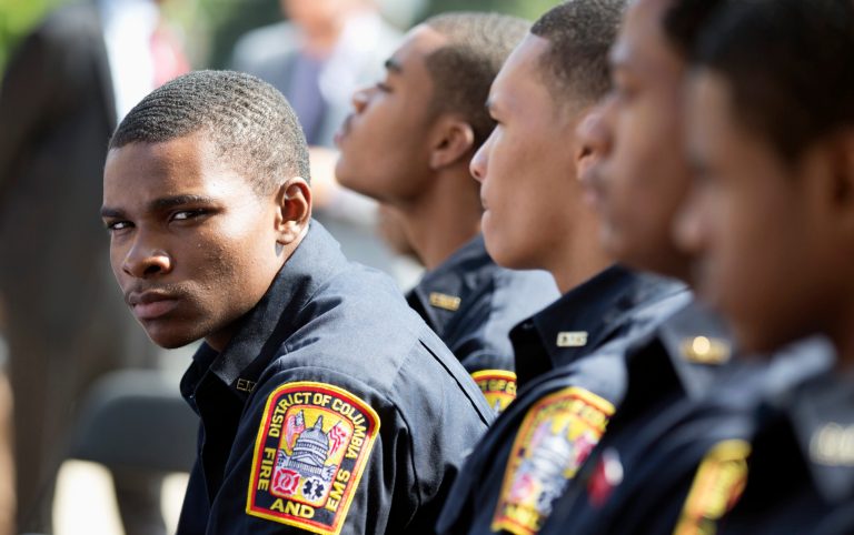   New Fire and Emergency Medical Services recruit, cadet Antonio Freeman, left, and others, attend a news conference where District of Columbia Mayor Vincent Gray, not in picture, announced the new Fire and Emergency Medical Services hires and displays the Districtâs newest ambulances during a news conference in Washington, Tuesday, Aug. 27, 2013. (AP Photo/Manuel Balce Ceneta)  