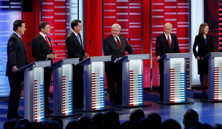 Republican presidential candidates, from left, former Pennsylvania Sen. Rick Santorum, Texas Gov. Rick Perry, former Massachusetts Gov. Mitt Romney, former Speaker of the House Newt Gingrich, Rep. Ron Paul, R-Texas, and Rep. Michele Bachmann, R-Minn, take their place for a Republican debate, Saturday, Dec. 10, 2011, in Des Moines, Iowa. (AP Photo/Eric Gay)