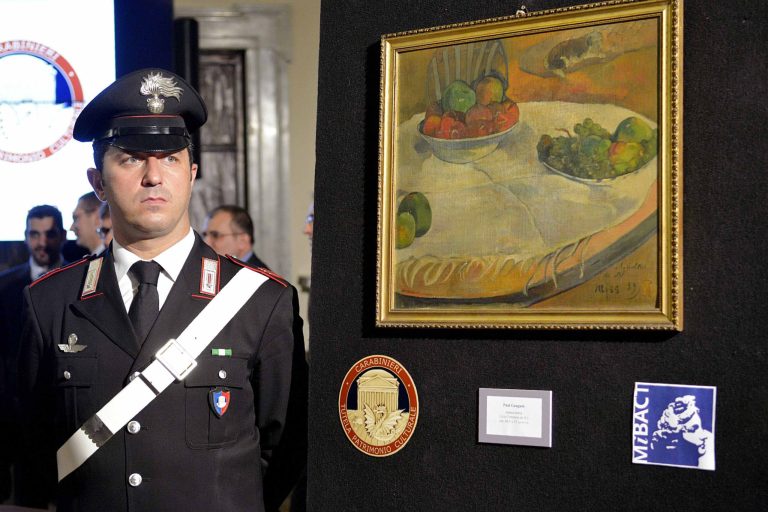 A carabiniere (Italian paramilitary police) officer stands by a Paul Gauguin still life recovered by authorities, during a press conference in Rome, Wednesday, April 2, 2014. Italian police say a Paul Gauguin still life, stolen from a private collection in Britain in 1970, hung on a kitchen wall in a retired Sicilian auto-worker's home for 40 years but now has been recovered by authorities. Maj. Massimiliano Quagliarella of the paramilitary Carabininieri art theft squad told The AP Wednesday the man displayed it in his kitchen, first in Turin, when he worked for Fiat, and then in Sicily, because the painting, depicting two bowls of fruit, seemed suitable to put near his table. Quagliarella said the man brought the painting, along with another of lesser value by Pierre Bonnard, at a 1975 Italian state railways auction of unclaimed lost items, for the equivalent then of about 100 dollars. The auctioneers didn't know they were stolen. (AP Photo/Daniele Leone, Lapresse)