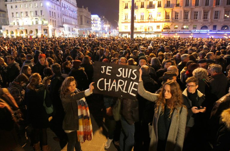 Demonstrators hold a banner reading 