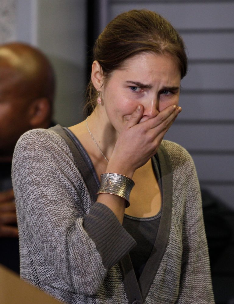 FILE - In this Tuesday, Oct. 4, 2011 file photo Amanda Knox gestures at a news conference in Seattle Tuesday, Oct. 4, 2011, after returning home from Italy. Italy's highest criminal court has overturned the acquittal of Amanda Knox in the slaying of her British roommate and ordered a new trial. The Court of Cassation ruled Tuesday, March 26, 2013 that an appeals court in Florence must re-hear the case against the American and her Italian-ex-boyfriend for the murder of 21-year-old Meredith Kercher. (AP Photo/Ted S. Warren, file)