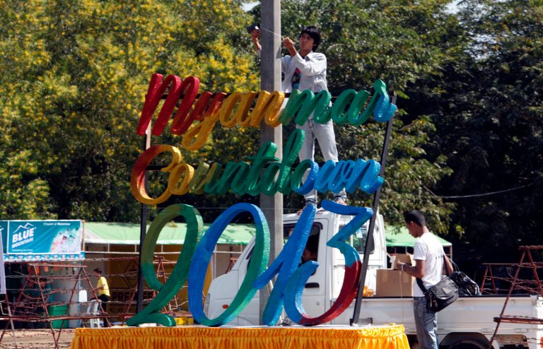   Workers prepare to set up a stage as preparations are underway for the country's first ever public New Year's countdown celebration, at Myoma grounds in Yangon, Myanmar, Monday, Dec. 31, 2012. Myanmar will ring in the new year with its first public countdown and a grand fireworks display Monday night in a celebration unprecedented in the former military-ruled country. (AP Photo/Khin Maung Win)  