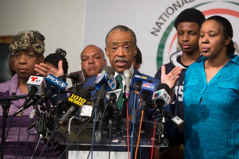 Rev. Al Sharpton speaks alongside Gwen Carr, mother of Eric Garner, left, and Esaw Garner, Garner's wife, during a news conference after a grand jury's decision not to indict a New York police officer involved in the death of Eric Garner. (AP Photo/John Minchillo)