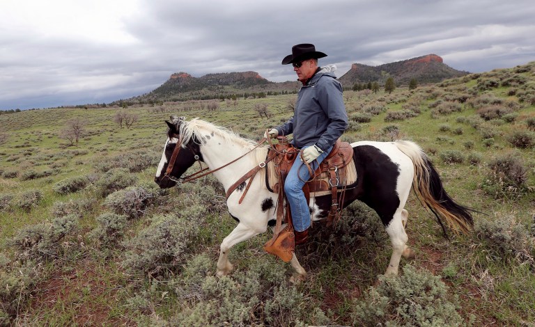 FILE - In this May 9, 2017, file photo, Interior Secretary Ryan Zinke rides a horse in the new Bears Ears National Monument near Blanding, Utah. Zinke on Monday, June 12, 2017, recommended that the new national monument in Utah be reduced in size and said Congress should step in to designate how selected areas of the 1.3 million-acre site are managed.