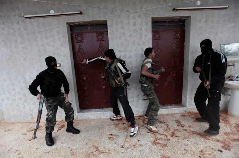   In this Monday, Dec. 17, 2012 photo, Syrian rebels attend a training session in Maaret Ikhwan, near Idlib, Syria. The training is part of an attempt to transform the rag-tag rebel groups into a disciplined fighting force. (AP Photo/Muhammed Muheisen)  