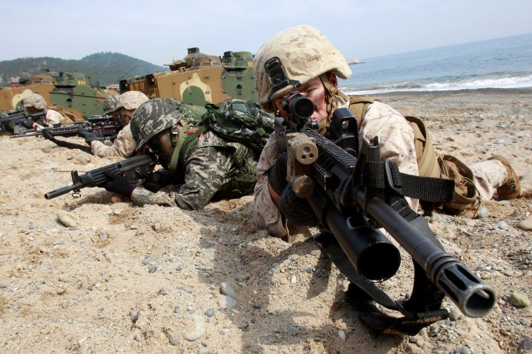 South Korean and U.S. Marines aim their machine guns during the U.S.-South Korea joint landing exercises called Ssangyong, part of the Foal Eagle military exercises, in Pohang, South Korea, Monday, March 31, 2014.  South Korea said North Korea has announced plans to conduct live-fire drills near the rivals' disputed western sea boundary. The planned drills Monday come after an increase in threatening rhetoric from Pyongyang and a series of rocket and ballistic missile launches in an apparent protest against the annual military exercises by Seoul and Washington.   (AP Photo/Ahn Young-joon)