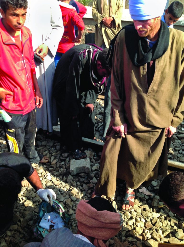 Egyptians gather body parts at the scene of a train crash that killed at least 47 people, most of them children near Assiut in southern Egypt, Saturday, Nov. 17, 2012. As one man picked up a body part he screamed: 