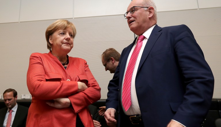 German Chancellor and Chairwomen of the German Christian Democratic Party, Angela Merkel, left, and the CDU faction leader Volker Kauder, right, arrive for a faction meeting at the German Federal Parliament, Bundestag, in the Reichstag building in Berlin, Germany, Monday, Nov. 20, 2017. (AP Photo/Michael Sohn)