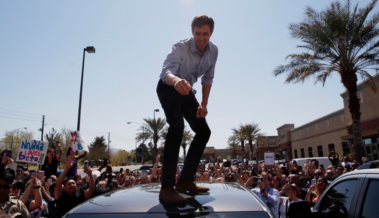 Democratic presidential candidate and former Texas congressman Beto O'Rourke speaks from the roof of his car to an overflow crowd at a campaign stop at a coffee shop Sunday, March 24, 2019, in Las Vegas.