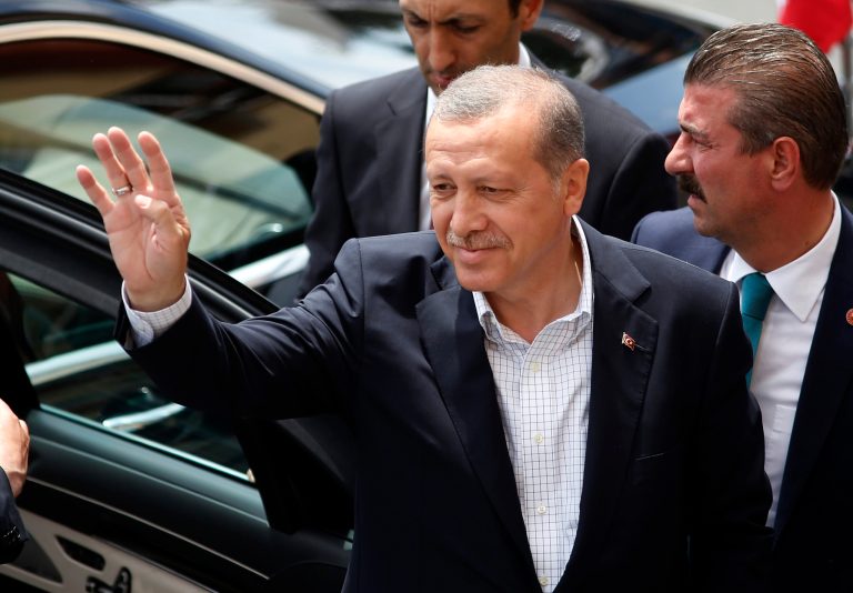 Turkey's President Recep Tayyip Erdogan waves to supporters Sunday after he voted at a polling station in Istanbul, Turkey. (AP Photo/Emrah Gurel)