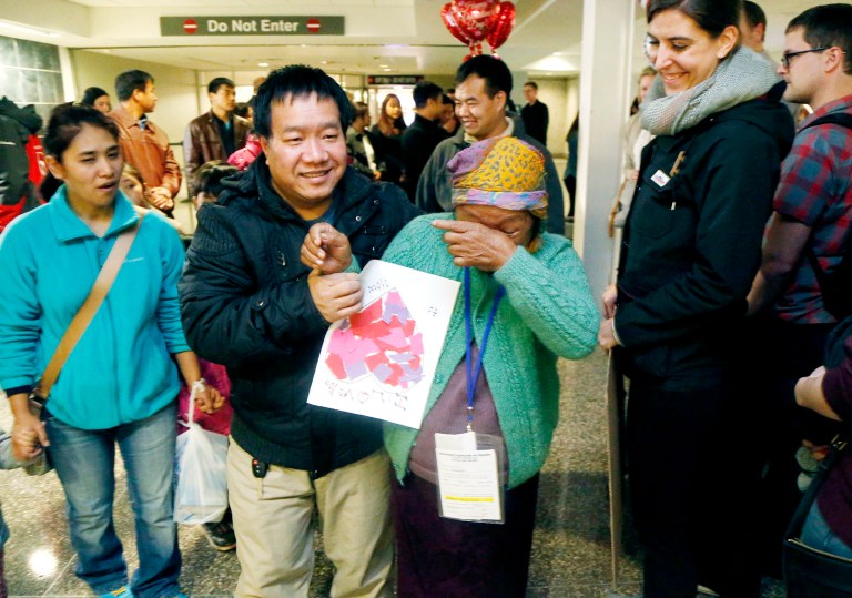 Thang Dim, center, a refugee from Myanmar, wipes away tears as family member Thang Piang escorts her to meet her grandchildren for the first time at Tulsa International Airport in Tulsa, Okla., on Feb. 14. (Matt Barnard/Tulsa World via AP)