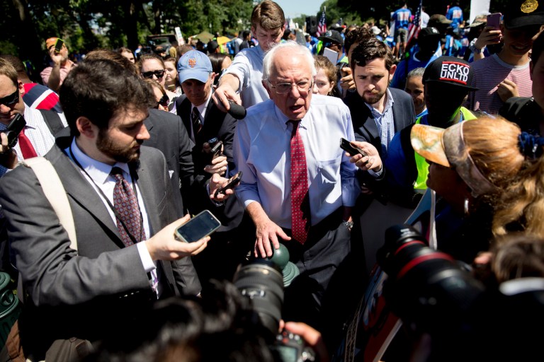 Democratic presidential candidate Sen. Bernie Sanders, I-Vt., speaks to reporters after speaking to federal contract workers at a rally on Capitol Hill in Washington, Wednesday, July 22, 2015, to push for a raise to the minimum wage to $15 an hour. (AP Photo/Andrew Harnik)