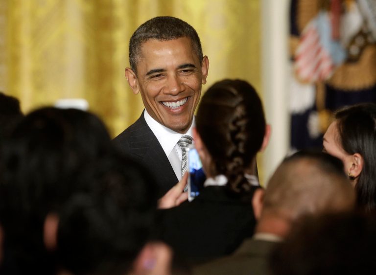 President Barack Obama greets new US citizens during a naturalization ceremony for active duty service members and civilians, Monday, March 25, 2013, in the East Room of the White House in Washington. (AP Photo/Pablo Martinez Monsivais)