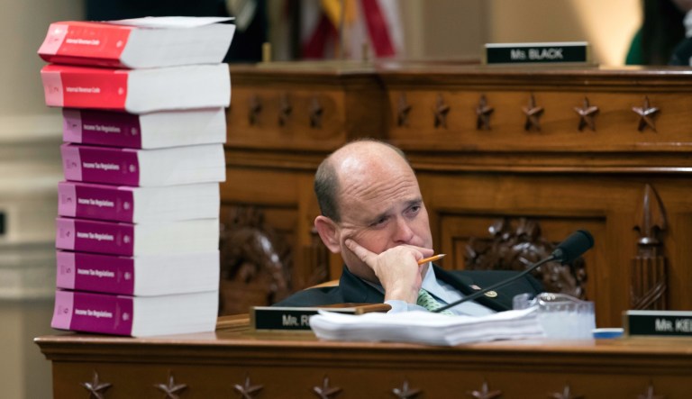 Rep. Tom Reed, R-N.Y., sat next to a stack of Internal Revenue Code volumes as the House Ways and Means Committee began the markup process of the GOP's far-reaching tax overhaul Monday. (AP Photo/J. Scott Applewhite)